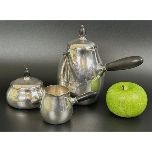 415 - A Georg Jensen Classic Art Nouveau silver three piece coffee service, with hammered decoration and e... 