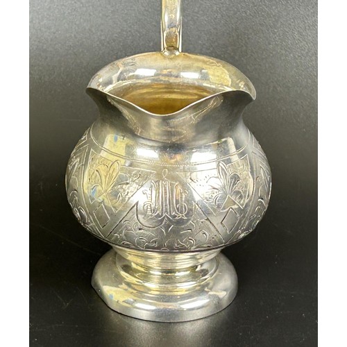 290 - A Russian silver coloured metal jug, with engraved decoration, 4.2 ozt, 10.5 cm high