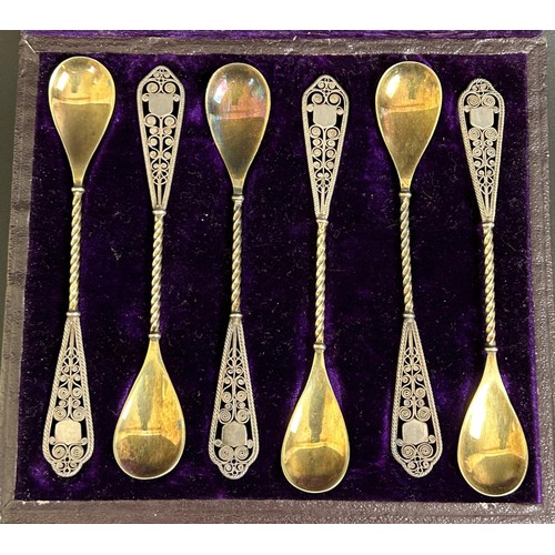 304 - A set of six Continental silver coloured metal spoons, with gilt bowls and filigree handles, ca... 