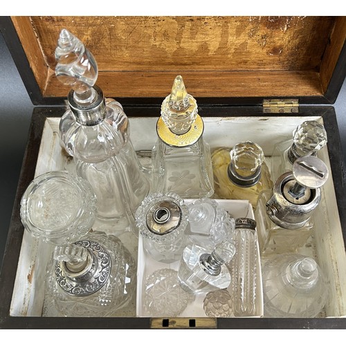 327 - A cut glass atomiser, with a silver mount, and assorted silver mounted glass bottles, in a walnut bo... 