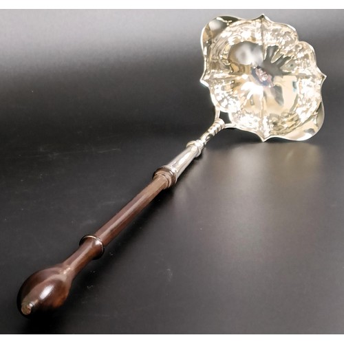 110 - A George III silver toddy ladle, with a turned wooden handle, and assorted silver coloured metal spo... 