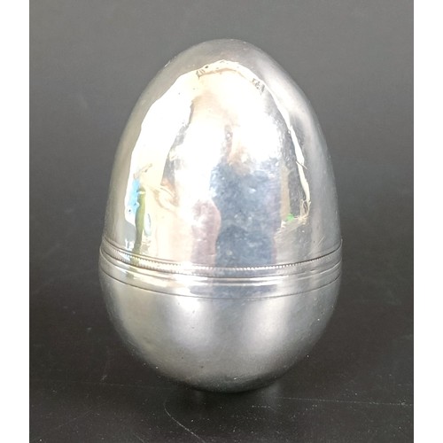 213 - A 19th century silver coloured metal nutmeg grater, in the form of the egg, 4 cm