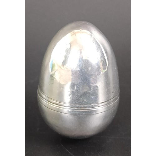 213 - A 19th century silver coloured metal nutmeg grater, in the form of the egg, 4 cm