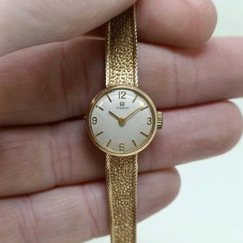 910 - A ladies 9ct gold Tissot wristwatch, 16.2 g all in