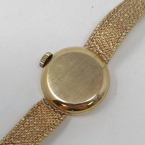 910 - A ladies 9ct gold Tissot wristwatch, 16.2 g all in