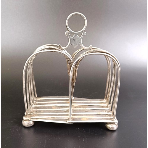 251 - A silver coloured metal collapsible toast rack, 10.5 cm wide