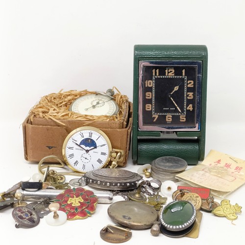 840 - A Jaeger-LeCoultre eight day travel clock, an oval silver locket on a chain, a pocket barometer, a s... 