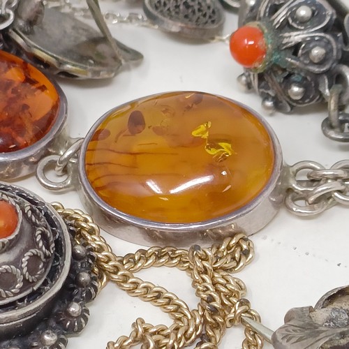 833 - An amber and silver coloured metal pendant on a chain, and assorted other costume jewellery