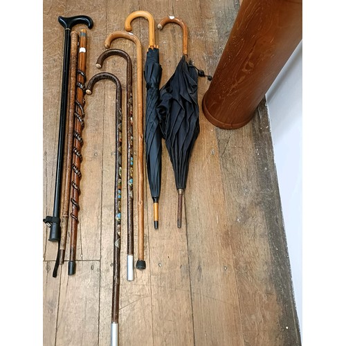 1150 - Assorted walking sticks, parasols, and a stick stand (9)