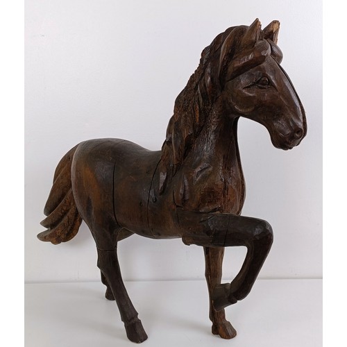 1016 - A wooden carved horse, 74 cm high...