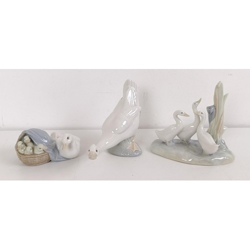 1036 - A Lladro lamp base, with two geese, 54 cm high, and three Nao figures (4)