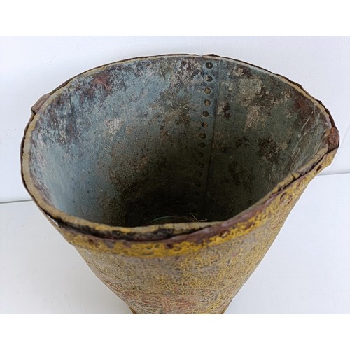 1056 - A painted leather fire bucket, 27 cm high...