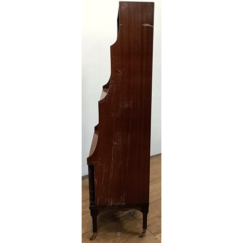 1221 - A mahogany waterfall bookcase, with a cupboard door to base, 51 cm wide