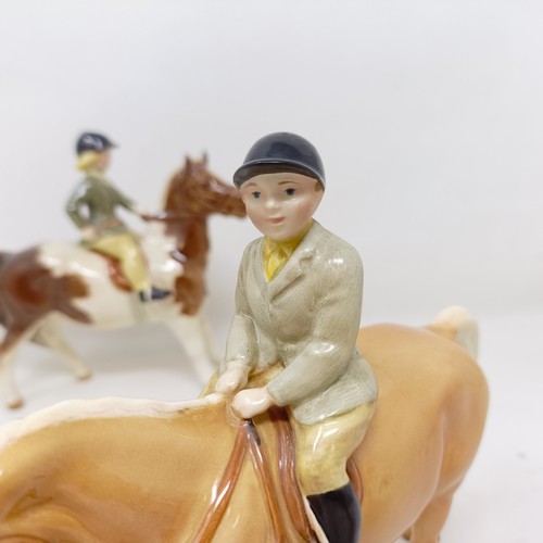 1002 - A Beswick Boy's Pony, palomino, 1500, and a Girl's Pony, skewbald, 1499, (chip to hoof), both g... 