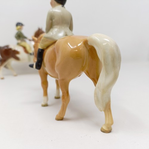 1002 - A Beswick Boy's Pony, palomino, 1500, and a Girl's Pony, skewbald, 1499, (chip to hoof), both g... 