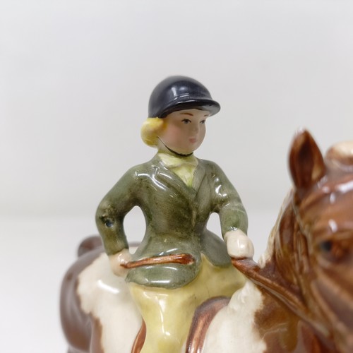 1002 - A Beswick Boy's Pony, palomino, 1500, and a Girl's Pony, skewbald, 1499, (chip to hoof), both g... 