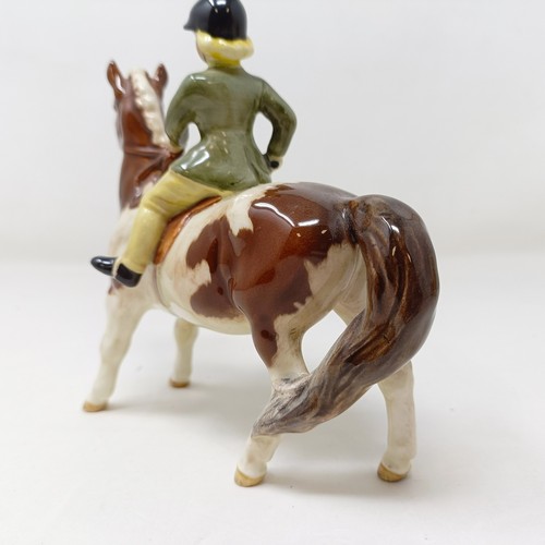 1002 - A Beswick Boy's Pony, palomino, 1500, and a Girl's Pony, skewbald, 1499, (chip to hoof), both g... 