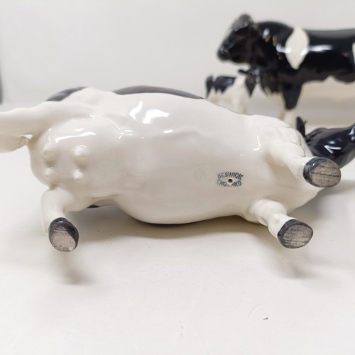 1004 - A Beswick Friesian Cow, 1362A, a Friesian Bull, 1439A, (horn chipped), and a Friesian Calf, 1249C, a...