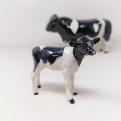 1004 - A Beswick Friesian Cow, 1362A, a Friesian Bull, 1439A, (horn chipped), and a Friesian Calf, 1249C, a...