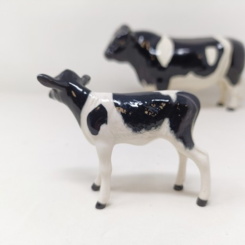 1004 - A Beswick Friesian Cow, 1362A, a Friesian Bull, 1439A, (horn chipped), and a Friesian Calf, 1249C, a...