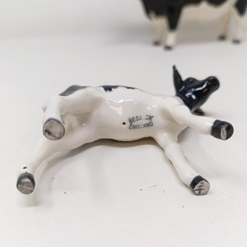 1004 - A Beswick Friesian Cow, 1362A, a Friesian Bull, 1439A, (horn chipped), and a Friesian Calf, 1249C, a...