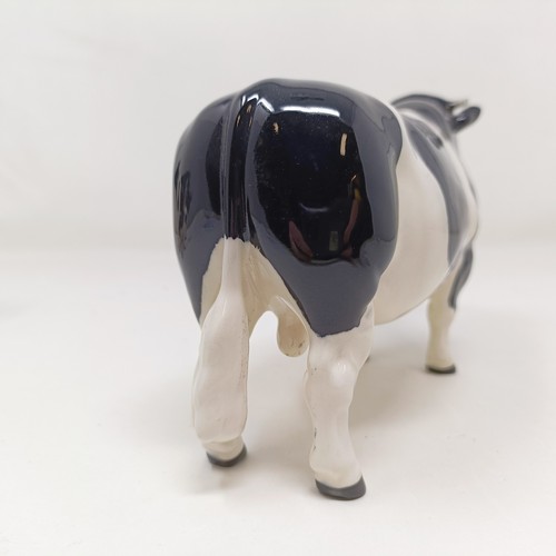 1004 - A Beswick Friesian Cow, 1362A, a Friesian Bull, 1439A, (horn chipped), and a Friesian Calf, 1249C, a...