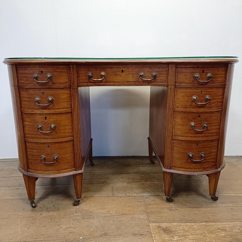 1245 - A late 19th/early 20th century inlaid satinwood kidney shaped desk, having a nine drawer configurati... 