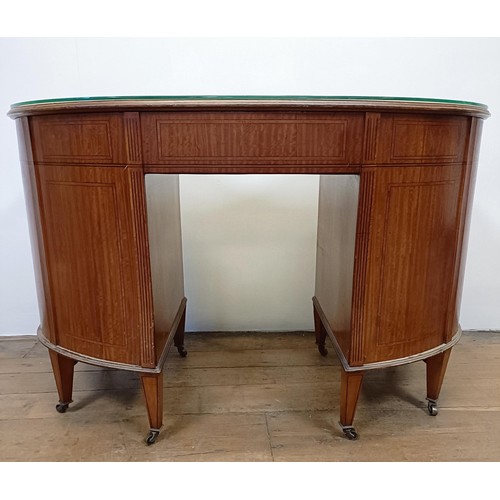 1245 - A late 19th/early 20th century inlaid satinwood kidney shaped desk, having a nine drawer configurati... 