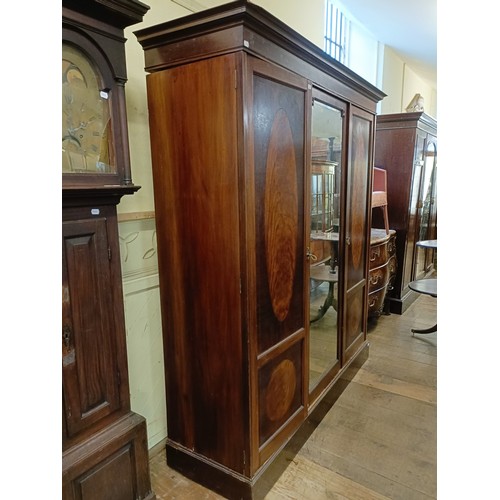 1285 - An early 20th century mahogany triple wardrobe, with a central mirrored door, 181 cm wide