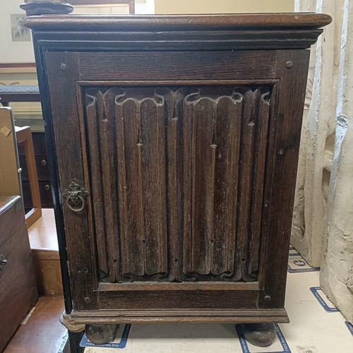 1223 - A pair of oak bedside cabinets, with linen fold decoration, 45 cm wide (2)