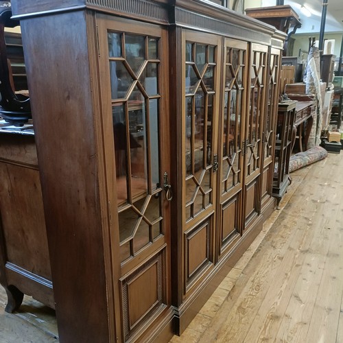 1232 - A mahogany breakfront bookcase, with five glazed doors, 206 cm wide