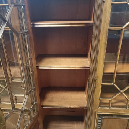 1232 - A mahogany breakfront bookcase, with five glazed doors, 206 cm wide