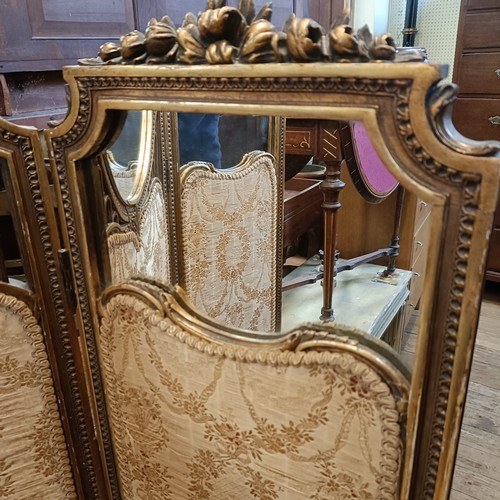 1228 - A gilt gesso three section folding screen, centre section with a mirror, 160 cm high