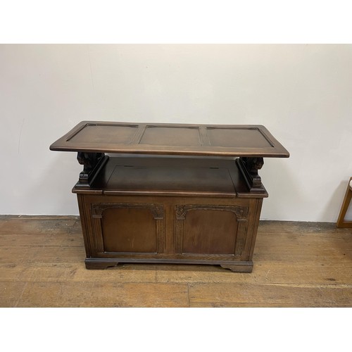 1204 - An oak monk's bench, 110 cm wide, a dresser, a drop leaf table, a radio, a waterfall bookcase, and a... 