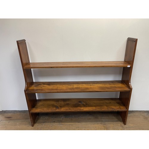 1204 - An oak monk's bench, 110 cm wide, a dresser, a drop leaf table, a radio, a waterfall bookcase, and a... 