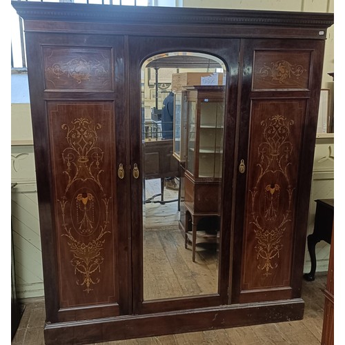 1289 - An early 20th century mahogany and marquetry inlaid triple wardrobe, with a central mirrored door, 1... 