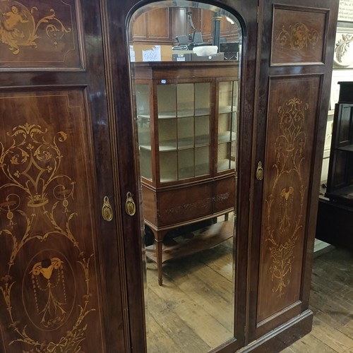 1289 - An early 20th century mahogany and marquetry inlaid triple wardrobe, with a central mirrored door, 1... 