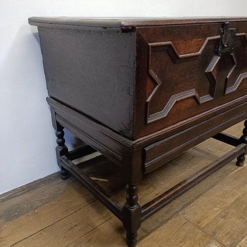 1294 - An oak box, with a hinged top, on a stand, 93 cm wide