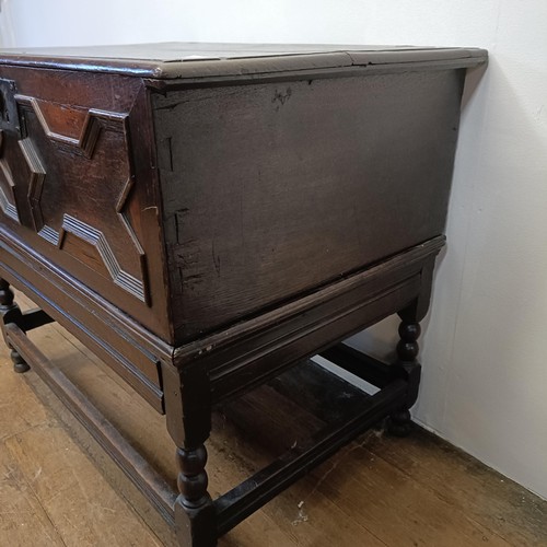 1294 - An oak box, with a hinged top, on a stand, 93 cm wide