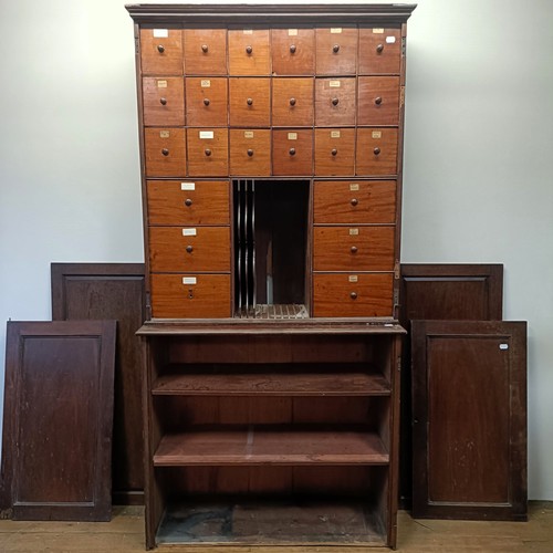 1317 - A mahogany estate cabinet, having a top with two cupboard doors, to reveal various drawers, in a bas... 