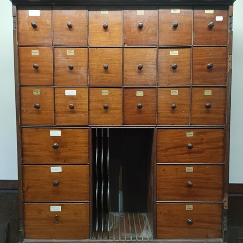 1317 - A mahogany estate cabinet, having a top with two cupboard doors, to reveal various drawers, in a bas... 