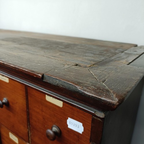 1317 - A mahogany estate cabinet, having a top with two cupboard doors, to reveal various drawers, in a bas... 