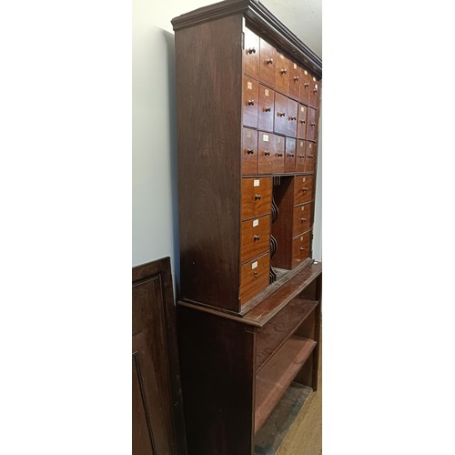 1317 - A mahogany estate cabinet, having a top with two cupboard doors, to reveal various drawers, in a bas... 