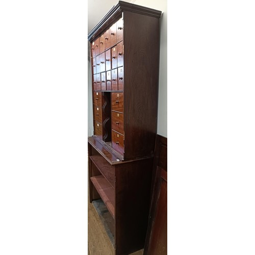 1317 - A mahogany estate cabinet, having a top with two cupboard doors, to reveal various drawers, in a bas... 