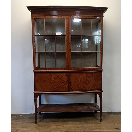 1300 - An early 20th century satinwood bow front display cabinet, 173 cm high x 116 cm wide