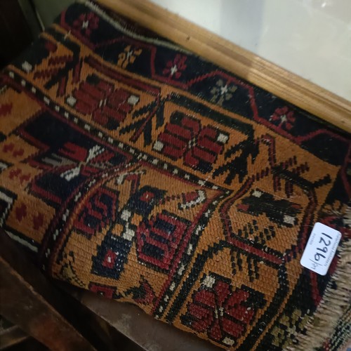 1296 - A mahogany side table, 50 cm wide, a pair of cast iron fire dogs, a pair of skis, a Persian rug, fou... 