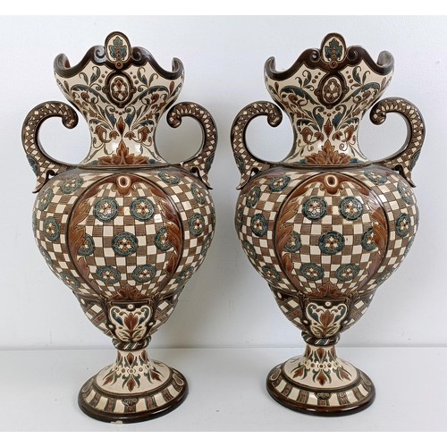 1061 - A Minton style tazza, various losses, 45 cm wide, and a pair of Continental vases, 40 cm high (3)...