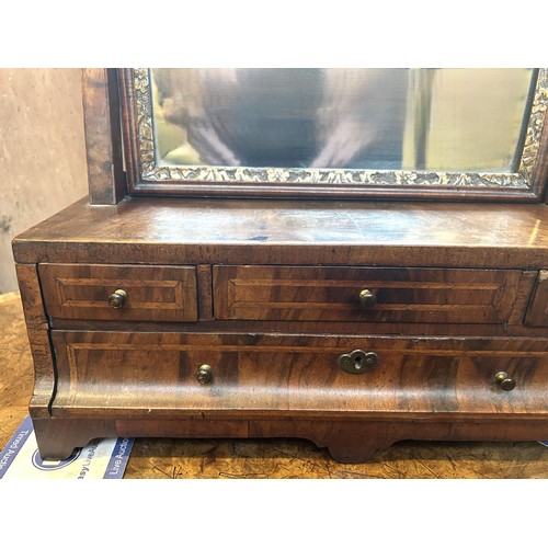 1310 - A 19th century walnut and gilt gesso bedroom mirror, the base having four drawers, 79 x 44 cm