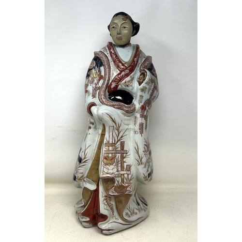 1091 - A Japanese Imari figure, with a painted wooden head, 50 cm high