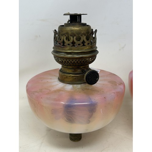 1099 - A pair of Vaseline glass oil lamp reservoirs, 17 cm diameter (2)